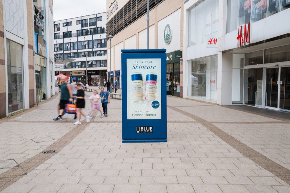 Digital advertising totem on a pedestrianised shopping street