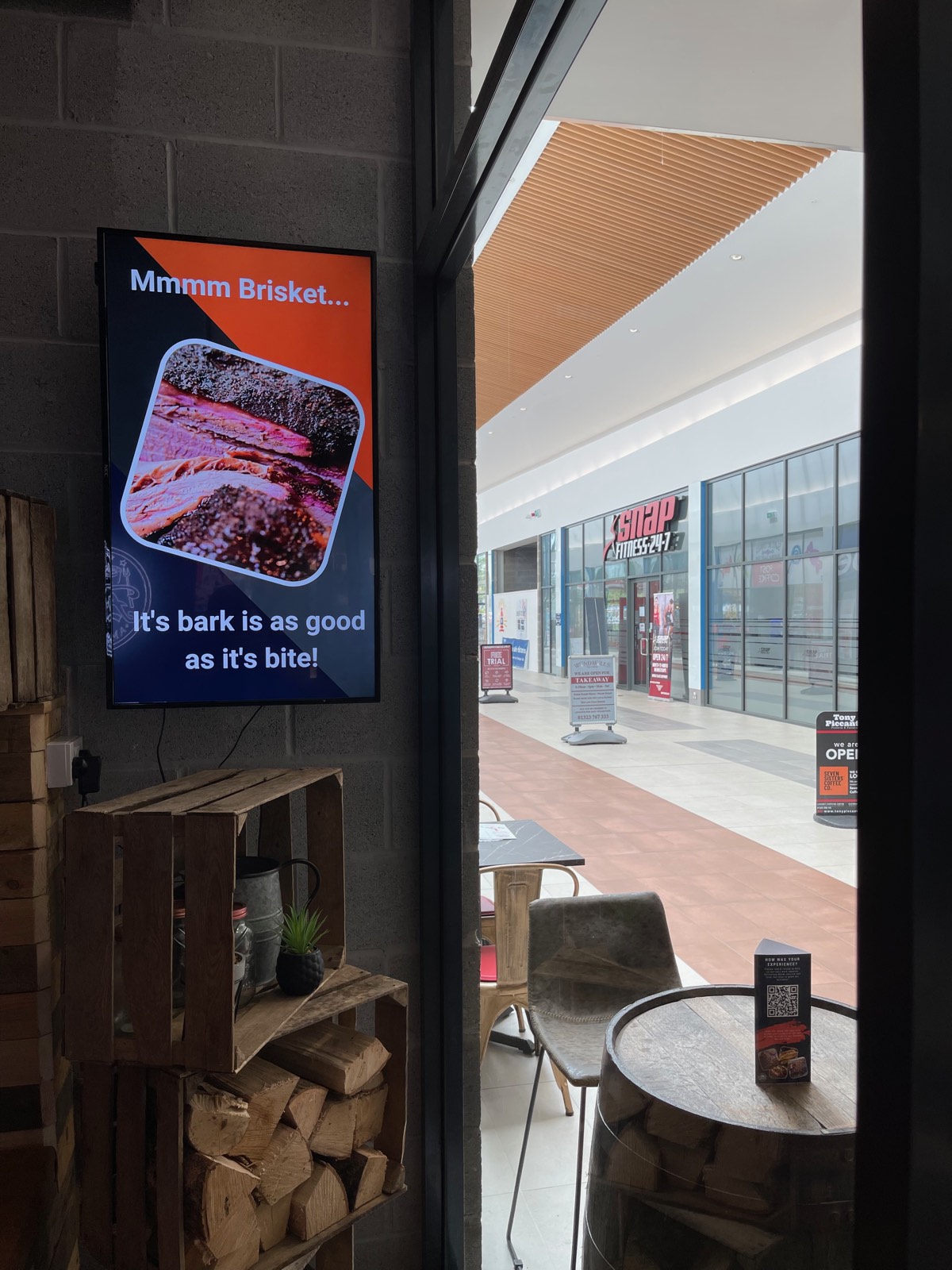 Digital signage screen showing a food promotion in a BBQ restaurant