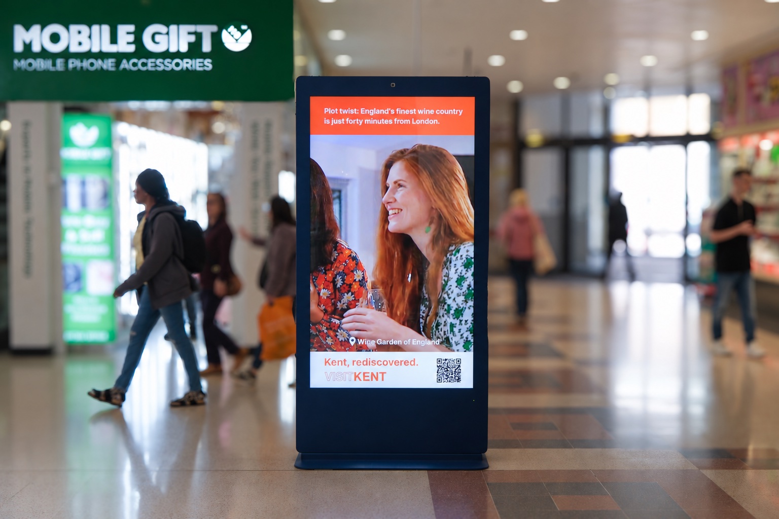 Digital advertising screen among shops in a shopping centre