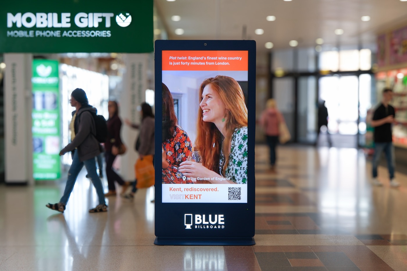 Digital advertising screen among shops in a shopping centre